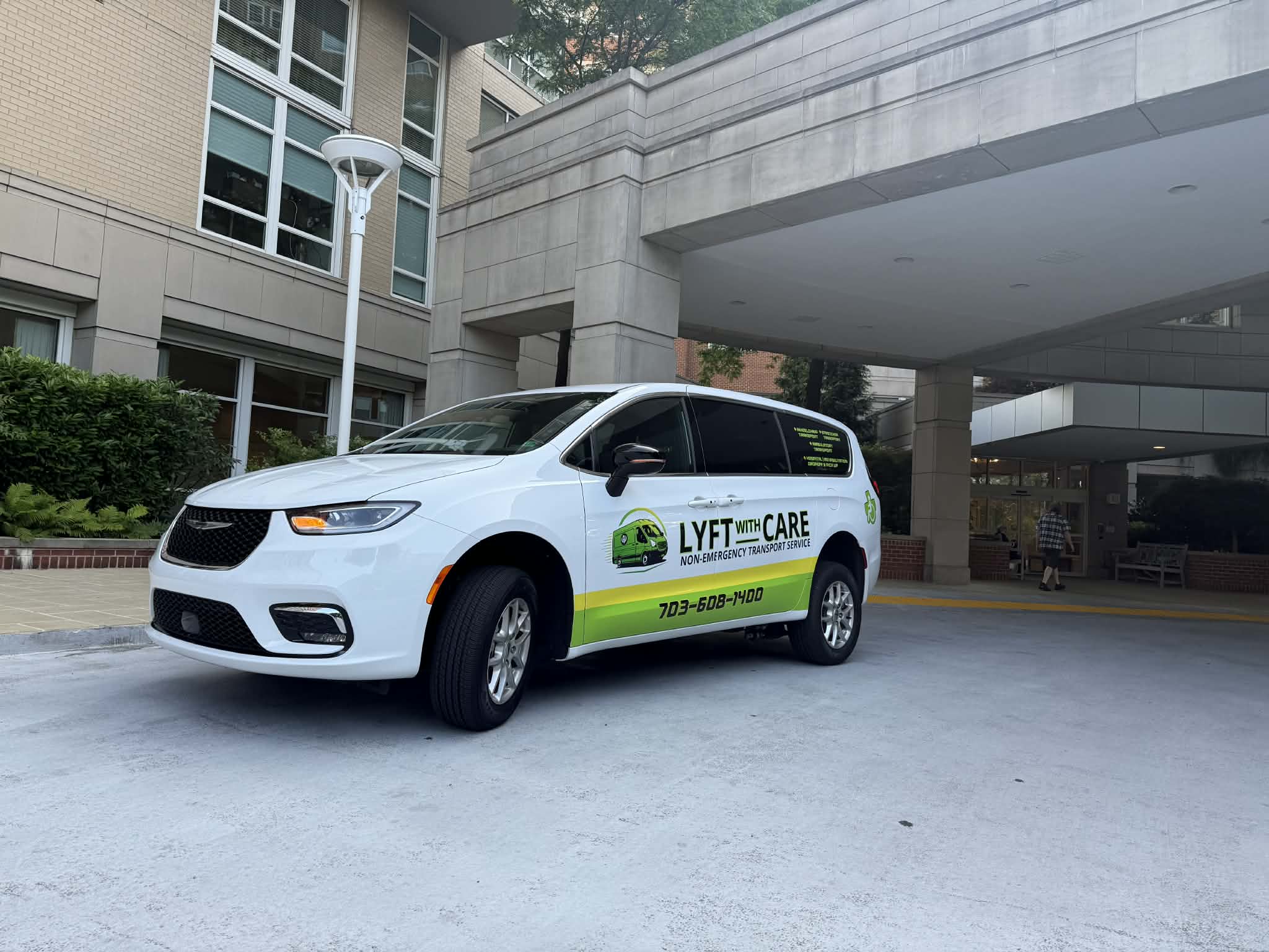 Lyft With Care medical transportation van at hospital pickup and drop-off entrance